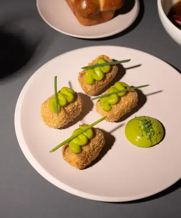 A dish of small bites served with a green sauce at Cellar 22. 657cb38d4ceefc30585d0a8f4045a9ac