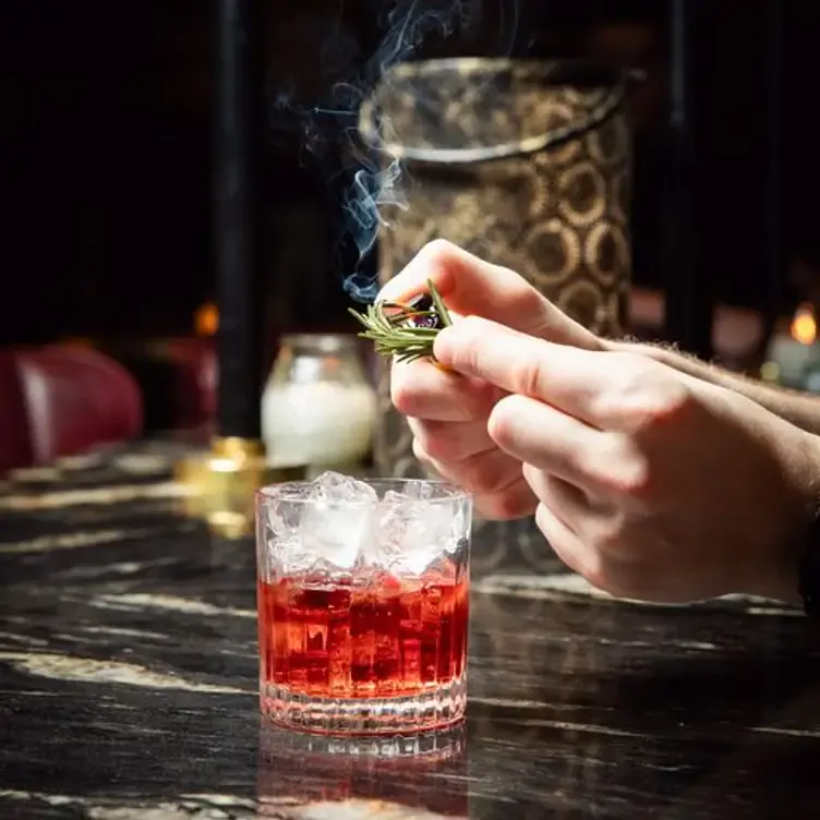 A rosemary negroni cocktail at Ralph and Finns, one of the best romantic restaurants in Glasgow