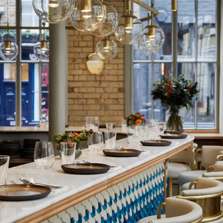 The interior of the restaurant with tables and chairs at Zahter, one of the best Turkish restaurants in central London.