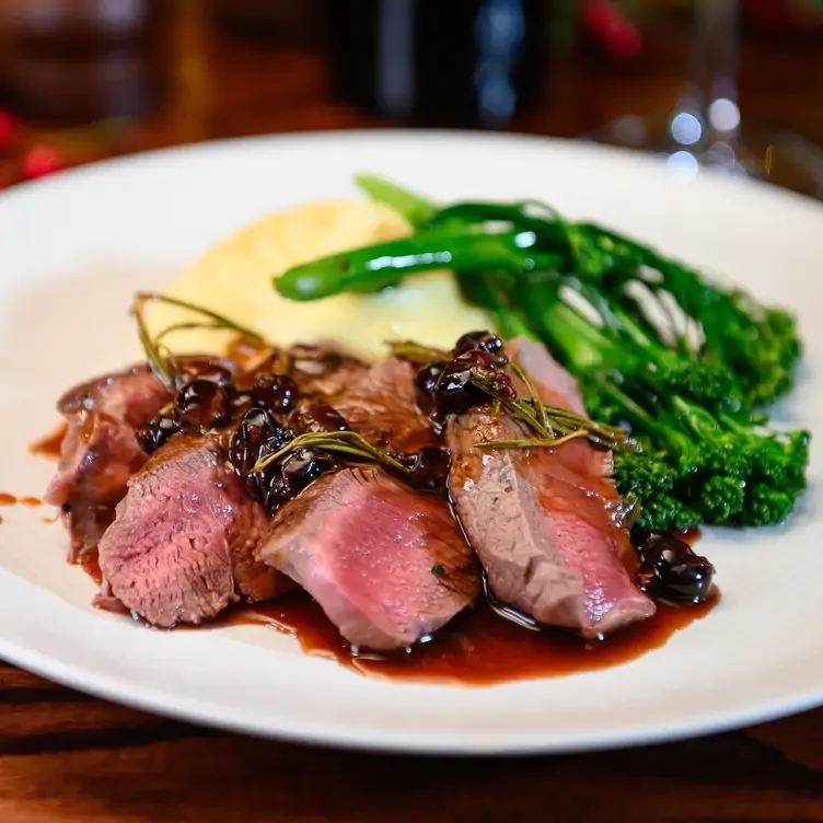 A steak with a side of mashed potatoes and greens at Café Royal, a restaurant in Edinburgh