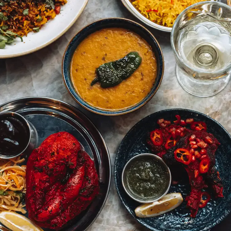 A table of several curry dishes at Namaste by Delhi Darbar, one of the best romantic restaurants in Glasgow.