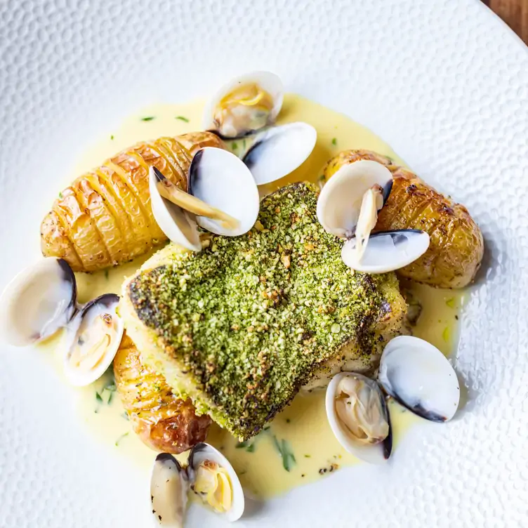 Roasted hake served with mussels and potatoes at Bon Appetit.