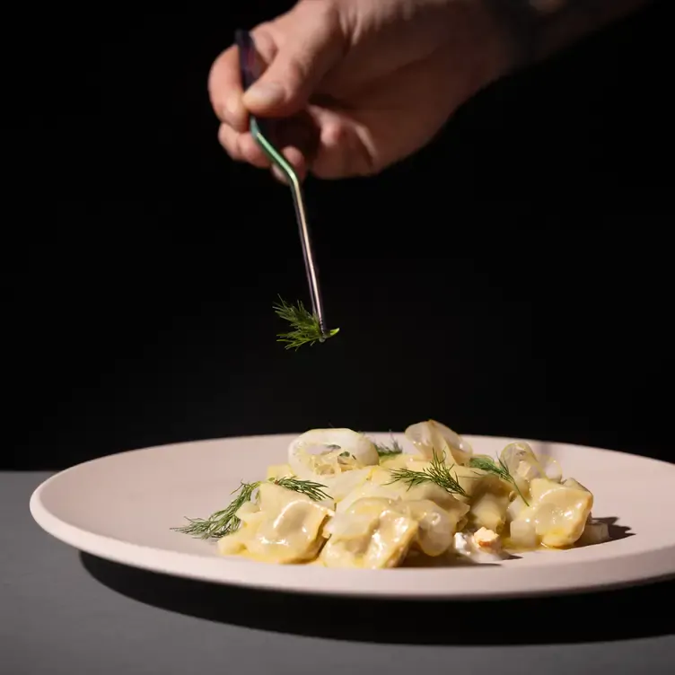 A chef puts the finishing garnish on a pasta dish served at Cellar 22, one of the most romantic restaurants in Dublin.