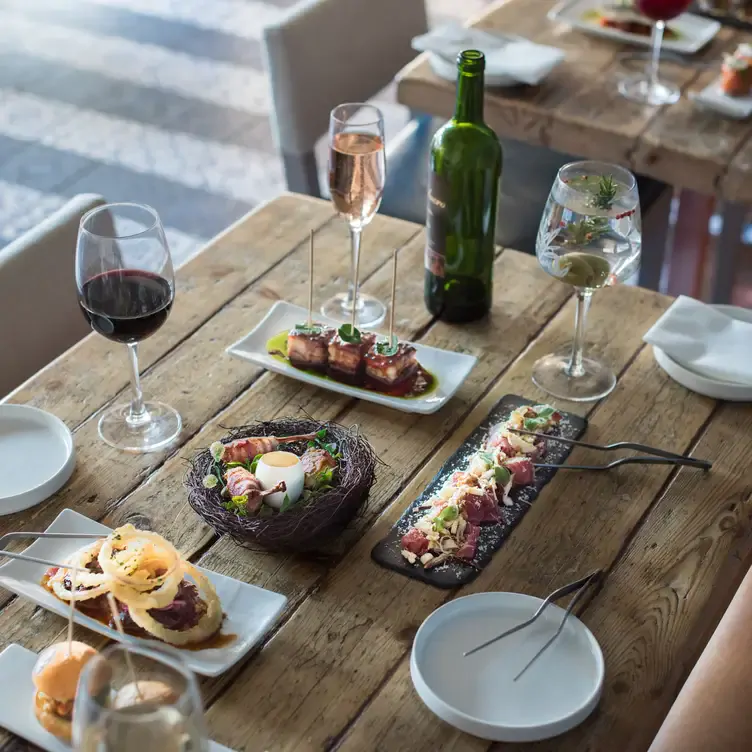 A table with tapas and wine at Bravas Tapas, one of the best tapas restaurants in London.