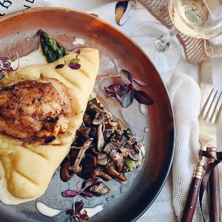 A poultry dish with mashed potatoes and mushrooms at Le Bistrot.