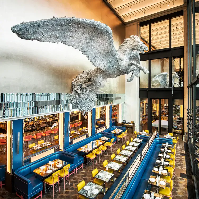 The tall dining room with the crystal encrusted Pegasus on the wall at Brasserie of Light.