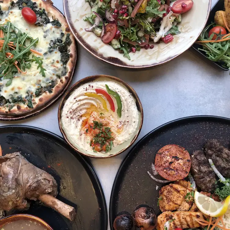 Hummus, flatbread, meats and vegetables at Grilandia, one of the best Lebanese restaurants in London.