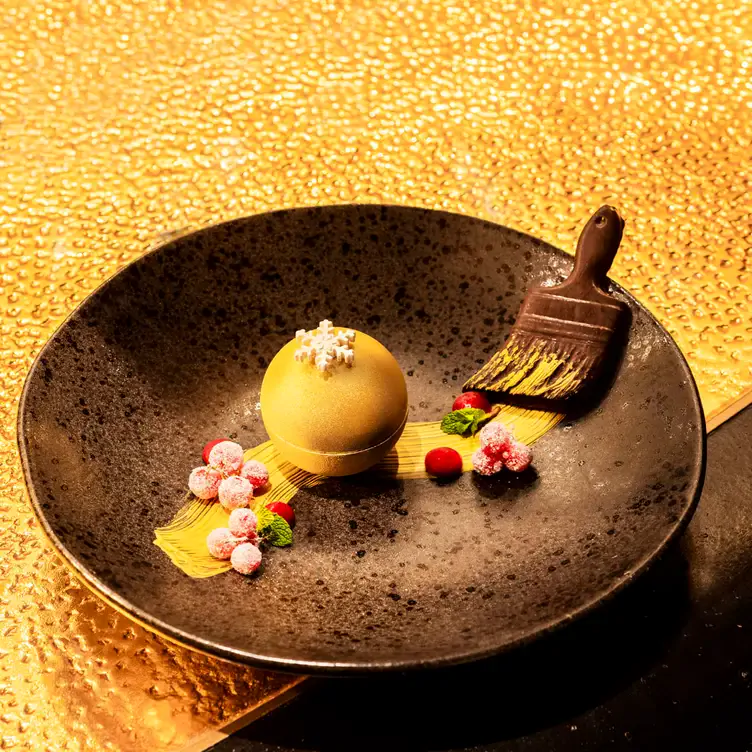 A creative gold bauble dessert with chocolate at Aqua Shard.