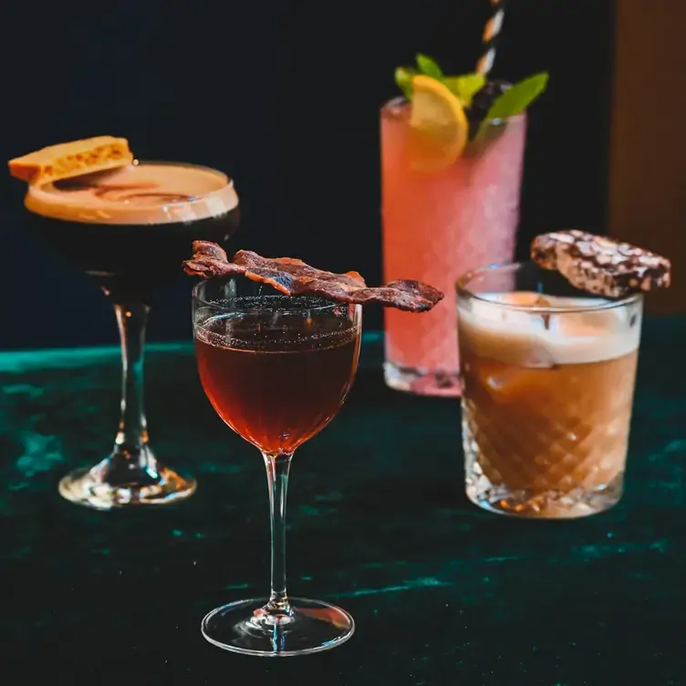 A variety of cocktails with garnish at The Spiritualist Glasgow, one of the best brunch spots in Glasgow.