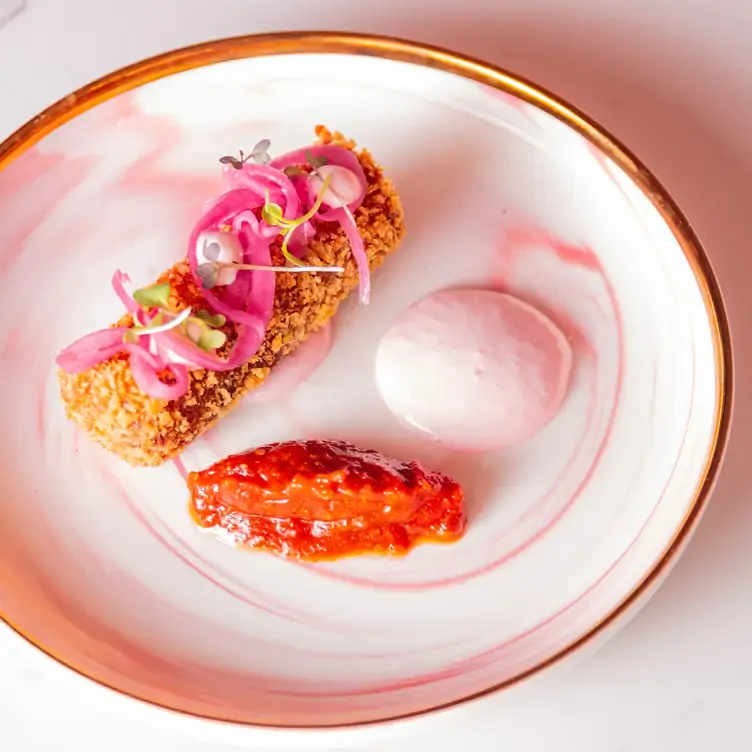 A croquette with pink onion garnish at Pink.