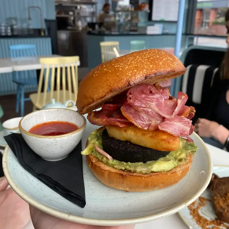 A brioche bun stack with avocado, bacon, black pudding, and hash brown at Mimi’s Bakehouse, one of the best brunch restaurants in Edinburgh.