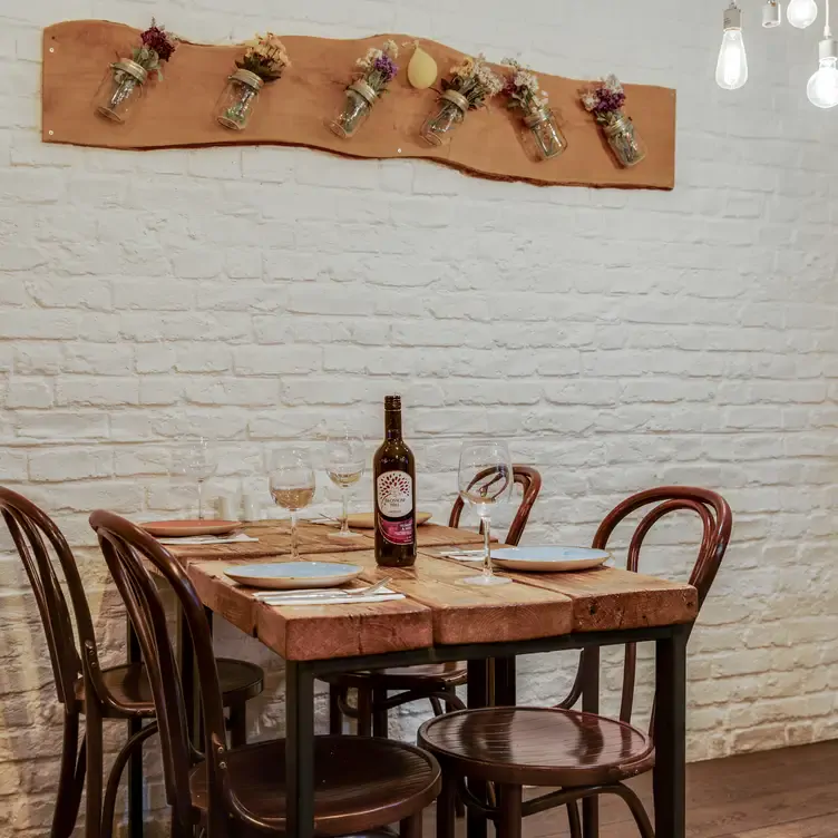 A table and chairs with a bottle of wine at Mira, one of the best Lebanese restaurants in London.