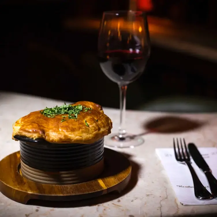 A pie served alongside a glass of red wine at Davy Byrnes, of the best pubs in Dublin.