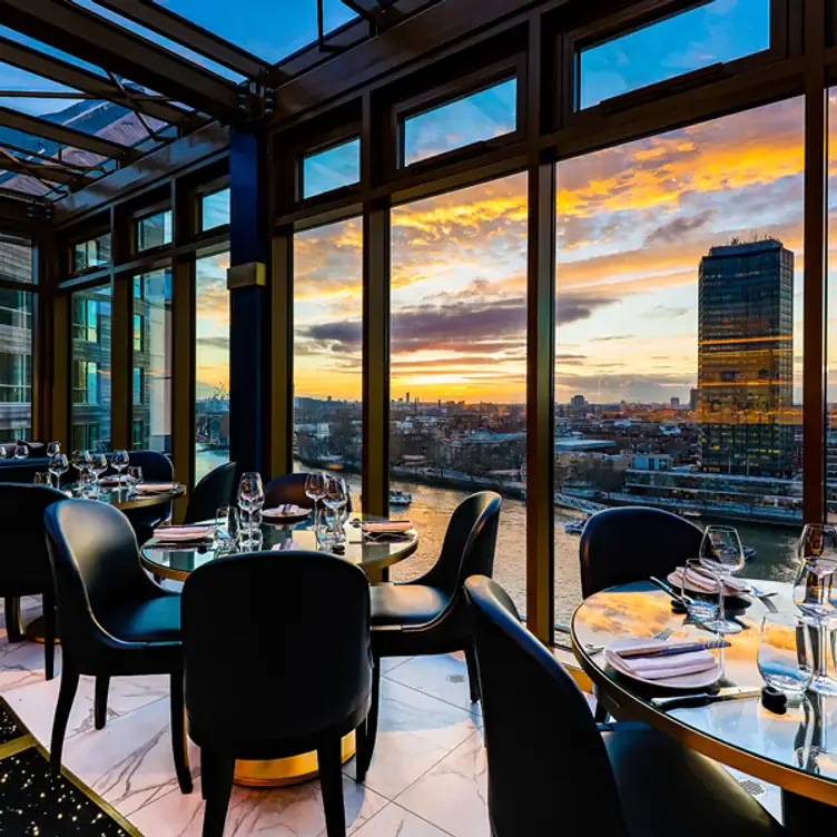 The interior of the restaurant and the skyline of London at Mezemiso, one of the best Lebanese restaurants in London.