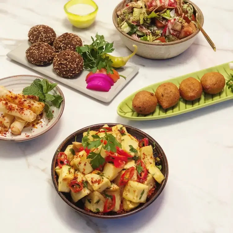 Colourful bowls of falafels, cheese and vegetables at Aline Lebanese Kitchen, one of the best Lebanese restaurants in London.