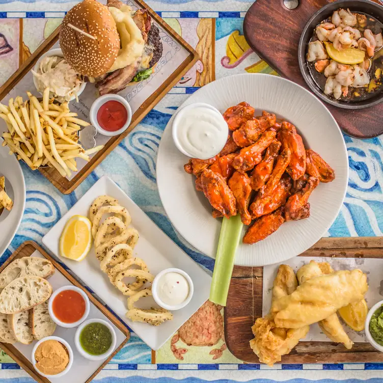 Multiple dishes including calamari, fried fish and a burger served at Blue Bar, one of Dublin’s best pubs.