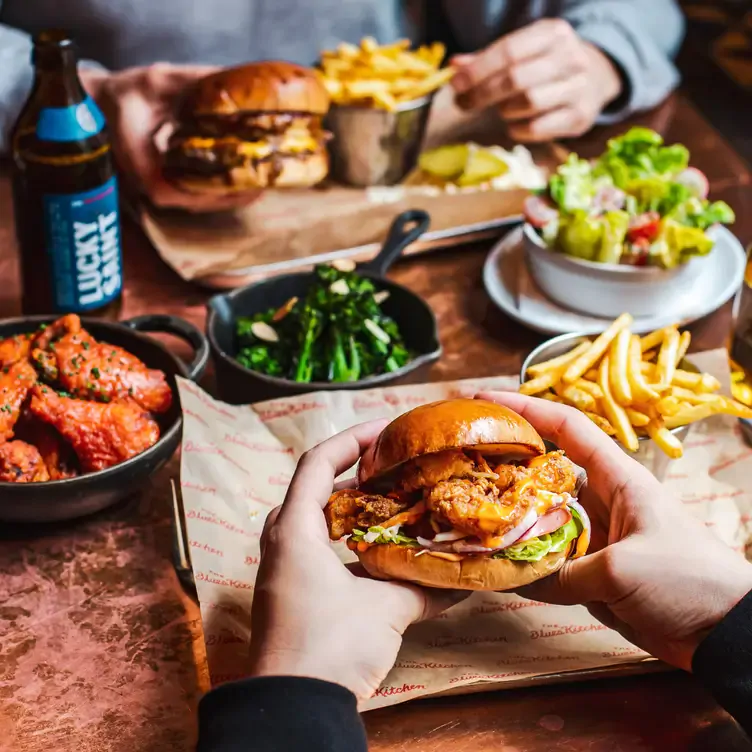 A diner lifts a fork of mac and cheese at The Blues Kitchen, one of the best bottomless brunches in Manchester.