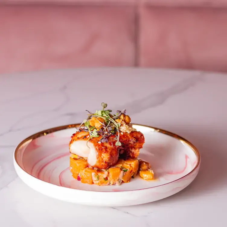 A fish dish on a pink plate at Pink, which serves one of the best brunches in Dublin.