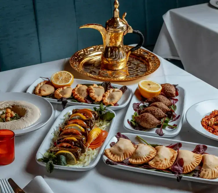 A traditional Lebanese spread with pastries, falafels and tea at Yamal Alsham Chelsea, one of the best Lebanese restaurants in London.