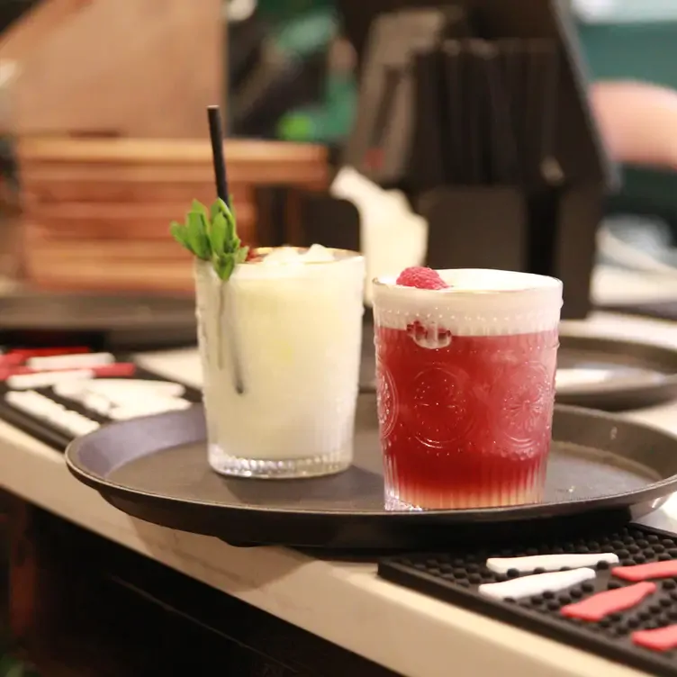 One white and one red cocktail on a drinks tray waiting to be served at Restaurant at The Woods, in Birmingham.