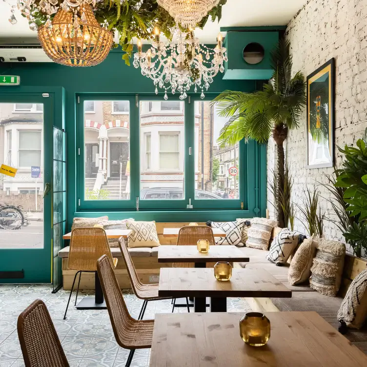 The interior of the restaurant with tables and chairs at Amiga, one of the best Mexican restaurants in south London.