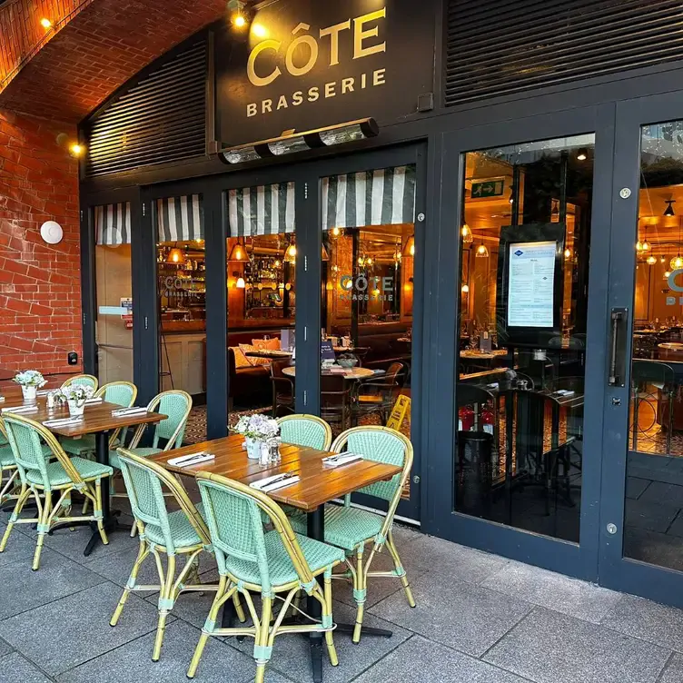 The entrance with outside tables and chairs at Côte Brasserie – Birmingham, one of the best brunches in Birmingham.