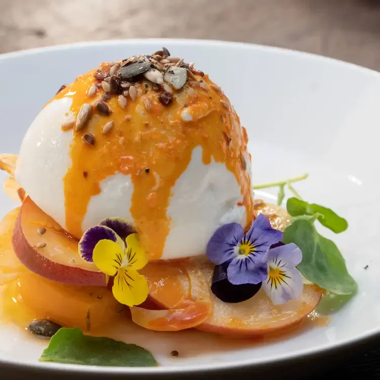 A dessert with fruit and ice cream, garnished with flowers, served at House Dublin, one of the best pubs in Dublin.