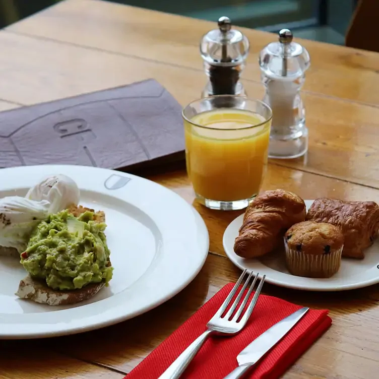 Avocado on toast with OJ and muffins at Café Football Old Trafford, one of the best places for brunch in Manchester.