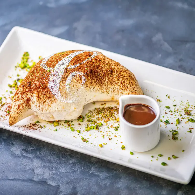 A dessert dish with pistachios and chocolate sauce at Carluccio’s – Solihull, one of the places with the best brunch in Birmingham.