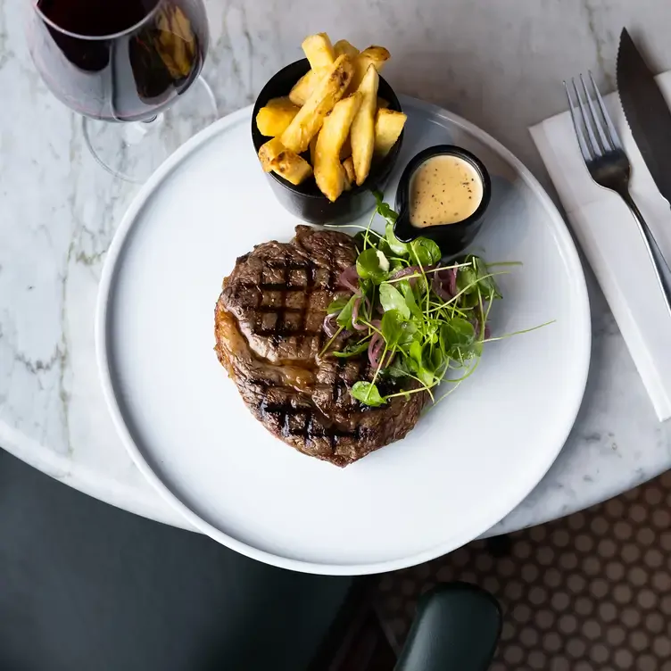 A plate of slices of fish stacked on top of each other and topped with a small amount of salad at Purty Kitchen, one of the best pubs in Dublin.