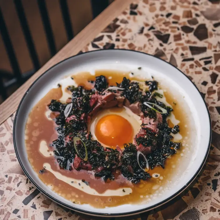 A ham and egg dish in a broth at BiBo by Dani Garcia, one of the best fancy restaurants in London.