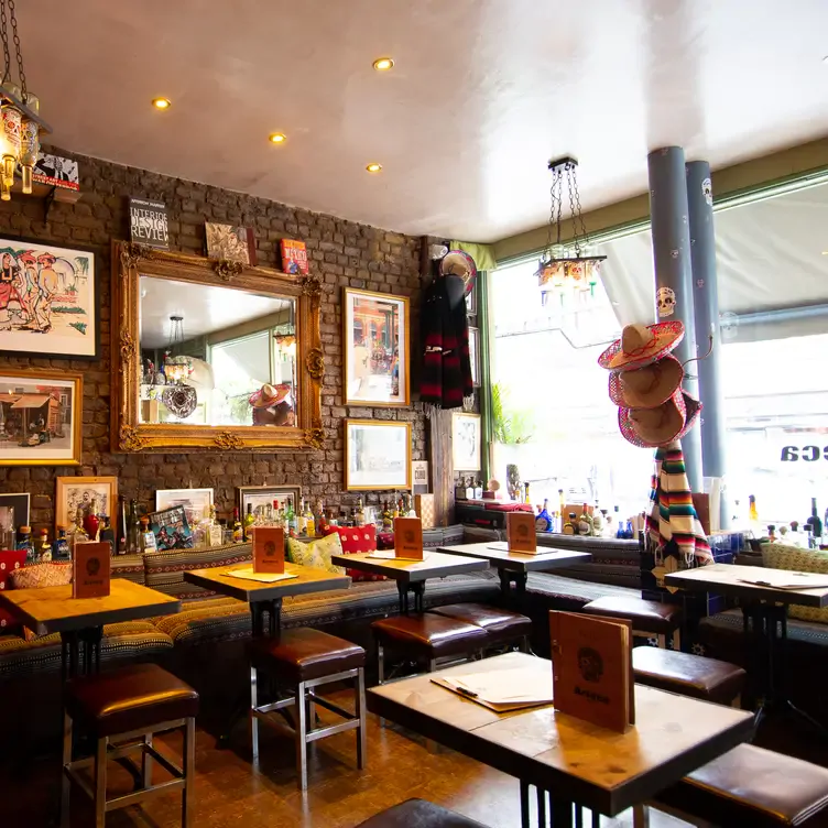 The interior of the restaurant, with tables and chairs, at Azteca Chelsea, one of the best Mexican restaurants in London.