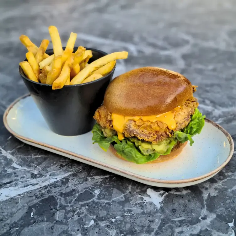 A burger served alongside a bowl of thin chips at Sandyford House, which serves up some of the best pub grub in Dublin.