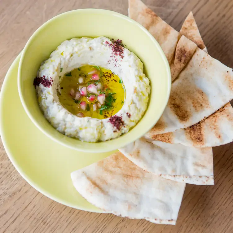 Flatbread and hummus in a bowl at Zufa, one of the best Lebanese restaurants in London.