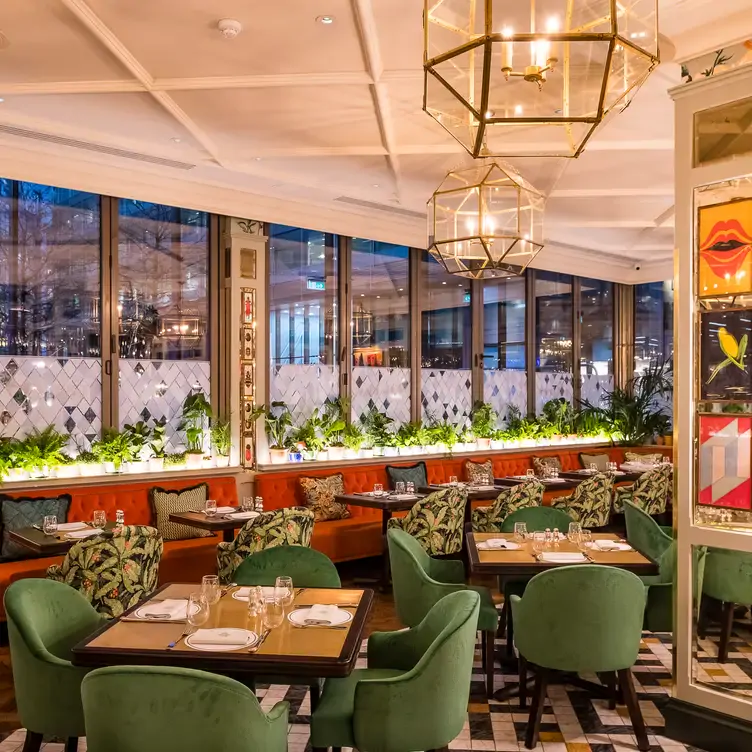 Tables with green patterned seats at The Ivy Brasserie, Spinningfields.