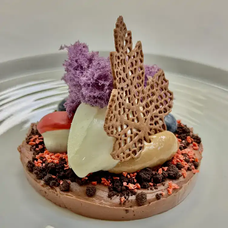 A fine dining dessert tart topped with a scoop of ice cream and a leaf-shaped biscuit at Locanda Locatelli, one of the best Italian MICHELIN star restaurants in London