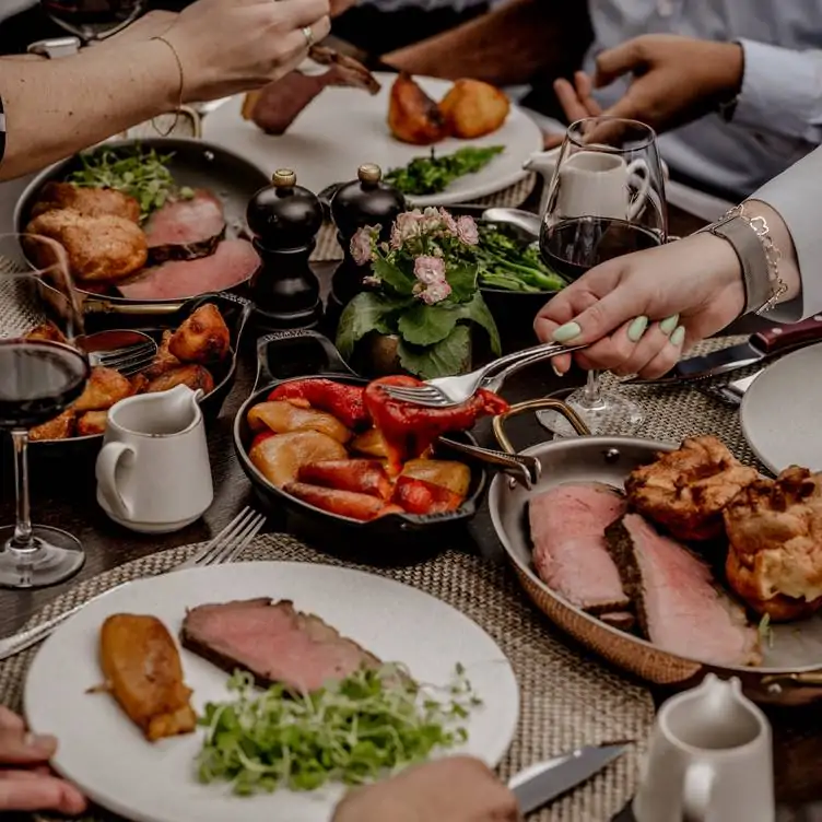 Diners sharing a Sunday roast at The Montagu Kitchen at Hyatt Regency London – The Churchill