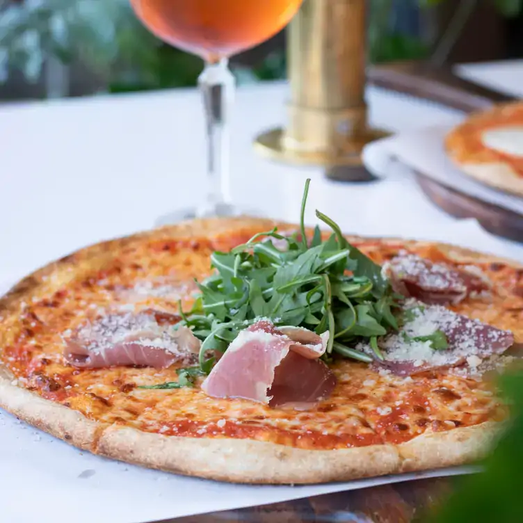 A pizza with ham and rocket at Proof Urban Italian, one of the best bottomless brunch restaurants in Dublin.