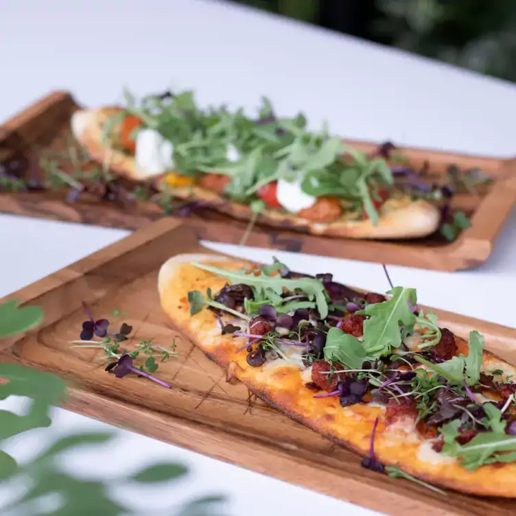 Two bruschetta flatbreads on bread boards at Proof Urban Italian, one of the best bottomless brunch restaurants in Dublin.