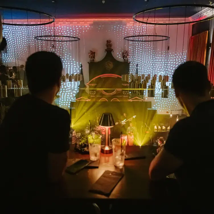 A couple of diners watch a live band from the second floor at Amazing Grace London, one of the best live music restaurants in London.