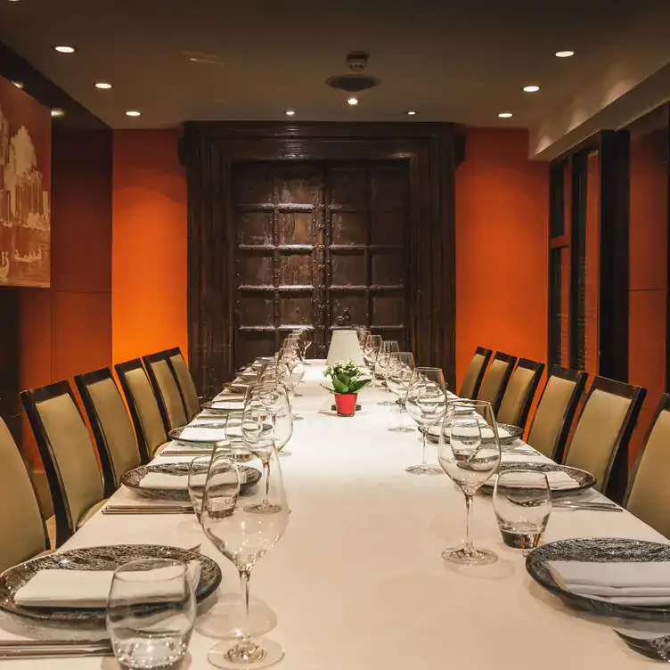 A private dining room with a wooden door in the background at Benares, one of the best Indian MICHELIN restaurants in London