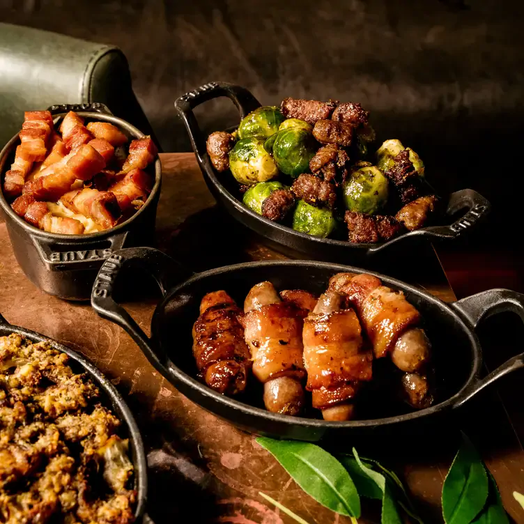 Pigs-in-blankets and brussels sprouts at Hawksmoor Dublin, one of the best food restaurants in Dublin.