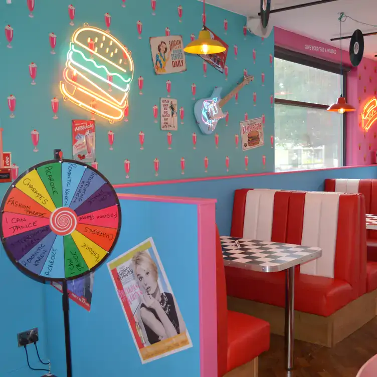 Colourful diner booths and wall art at Karen’s Diner Birmingham, one of Birmingham’s best bottomless brunch places.