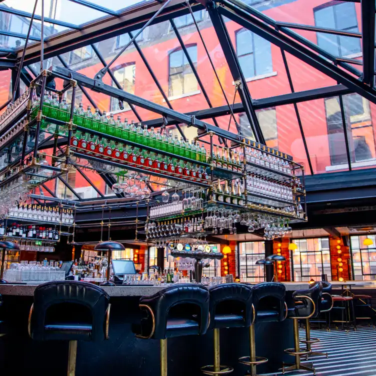 The black and gold bar under a glass roof at Roberta's.