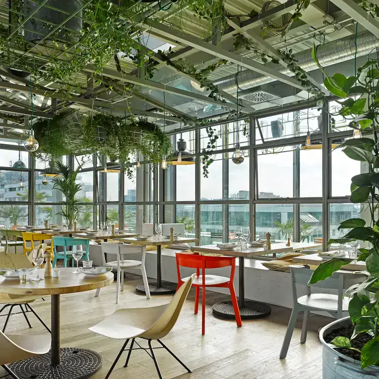 The rooftop green-filled interiors with views over the city at NENI Berlin, one of the best rooftop restaurants in Berlin.