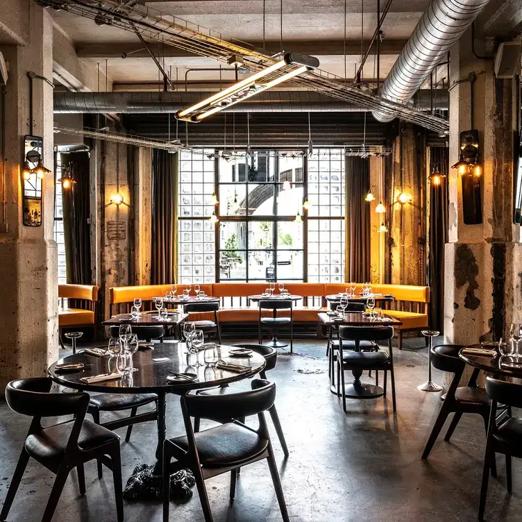 The modern interior of the restaurant dining room at Bread Street Kitchen & Bar, one of the best riverside restaurants in London.