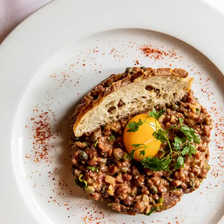 Steak tartare served with a slice of bread at Au Pied de Cochon, one of Paris’ best restaurants.