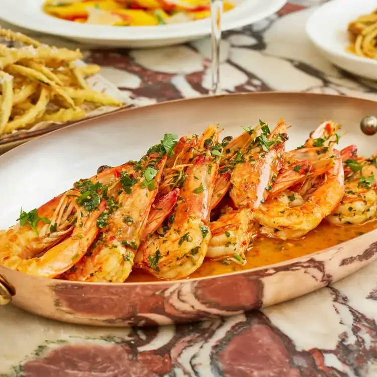 A serving dish of tiger prawns at Daphne’s, one of the best restaurants in Chelsea, London.