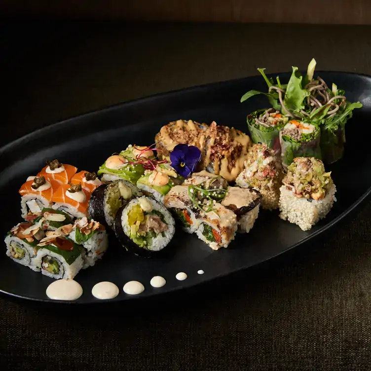 A platter with multiple different sushi rolls served at Bloom Sushi, one of the best restaurants in Paris.