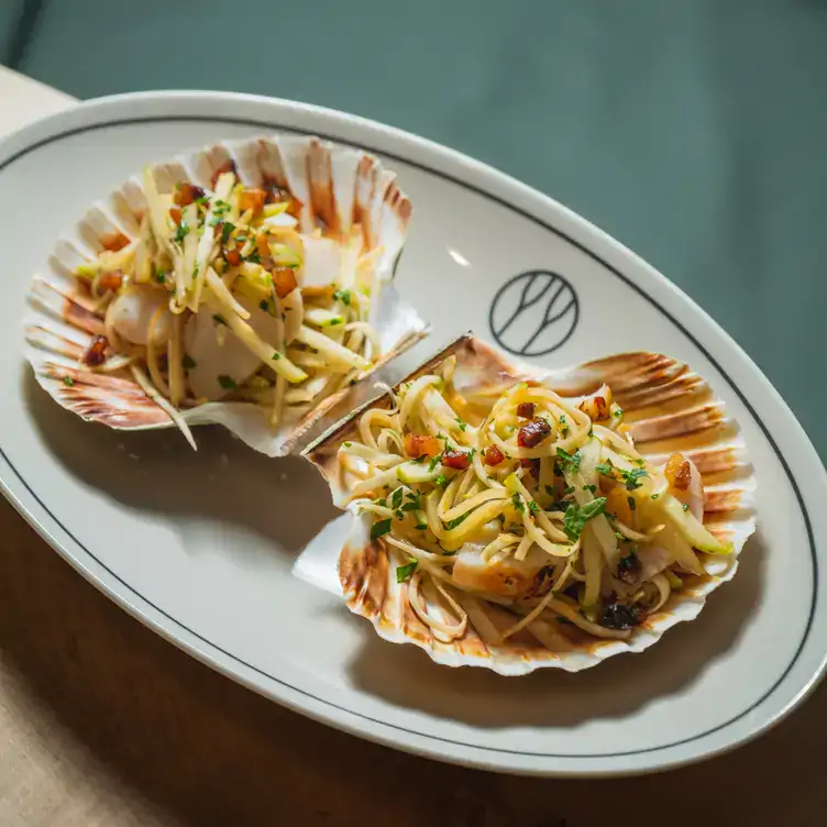 Scallop dish served on the shell at The Black Grape, one of the best seafood restaurants in Edinburgh.